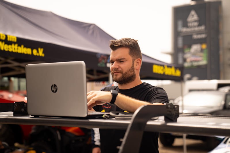 Race engineer analysing driving data in the paddock